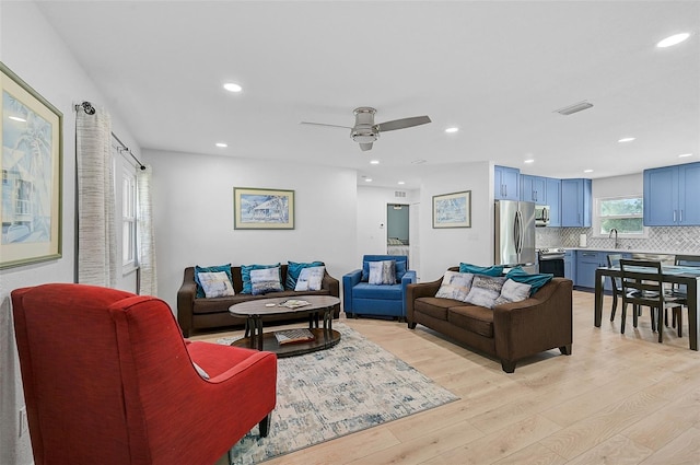 living area featuring recessed lighting, ceiling fan, light wood-type flooring, and visible vents
