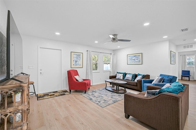 living room with a ceiling fan, visible vents, recessed lighting, and light wood finished floors
