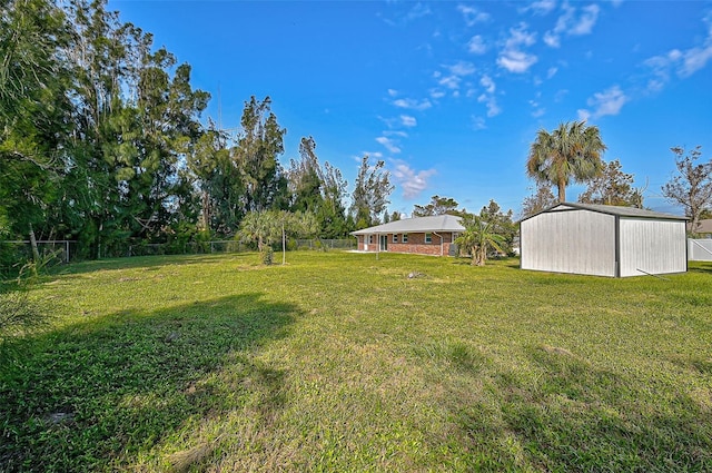 view of yard with a fenced backyard and an outdoor structure