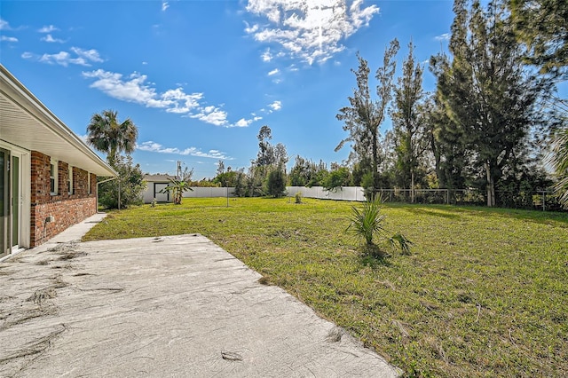 view of yard with fence and a patio area
