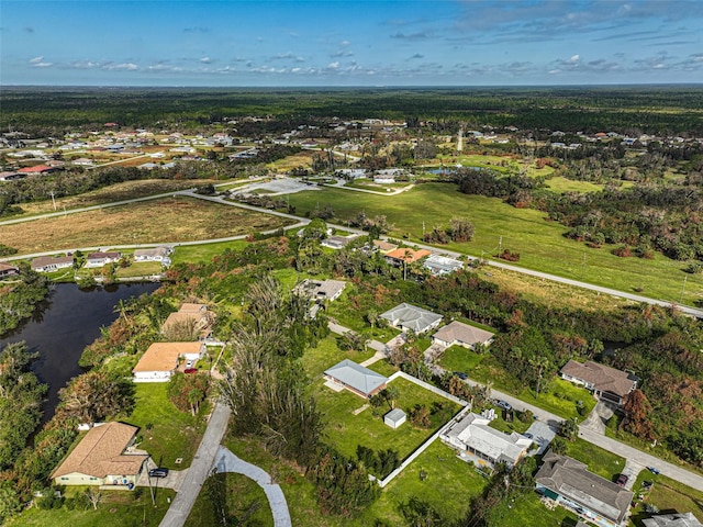 drone / aerial view featuring a water view and a residential view