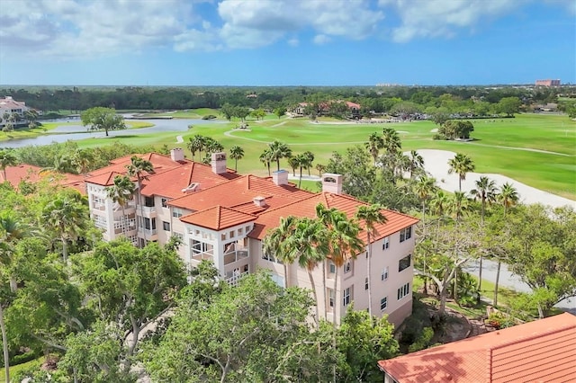 birds eye view of property with a water view and view of golf course