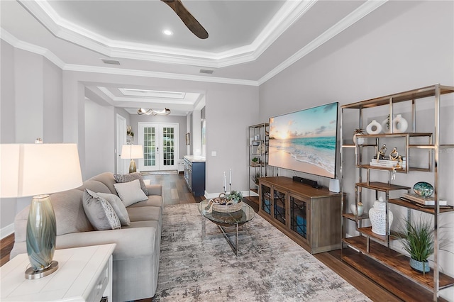 4625 Foxtail Dr, Parrish, FL 34219 - living room featuring a raised ceiling, wood finished floors, crown molding, ceiling fan, and baseboards