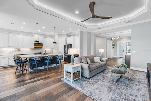 4625 Foxtail Dr, Parrish, FL 34219 - living area with dark wood-style flooring, crown molding, a ceiling fan, a raised ceiling, and recessed lighting