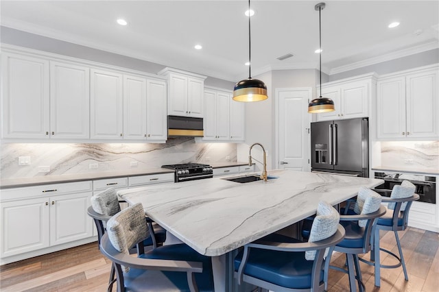 4625 Foxtail Dr, Parrish, FL 34219 - kitchen with a sink, high quality fridge, wall oven, gas range oven, and ornamental molding