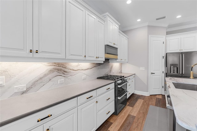 4625 Foxtail Dr, Parrish, FL 34219 - kitchen featuring high quality appliances, ornamental molding, recessed lighting, a sink, and white cabinetry