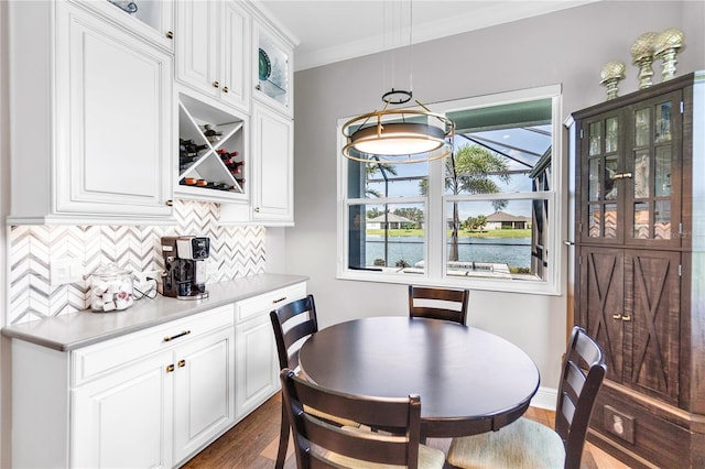 4625 Foxtail Dr, Parrish, FL 34219 - dining room with dark wood-type flooring, crown molding, and a water view