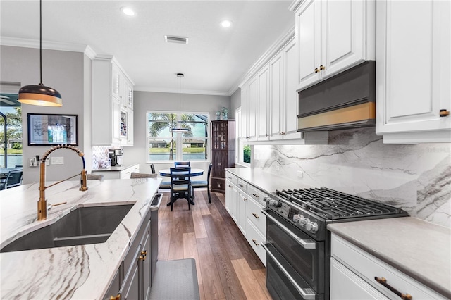 4625 Foxtail Dr, Parrish, FL 34219 - kitchen featuring range with two ovens, a sink, white cabinetry, dark wood-type flooring, and recessed lighting