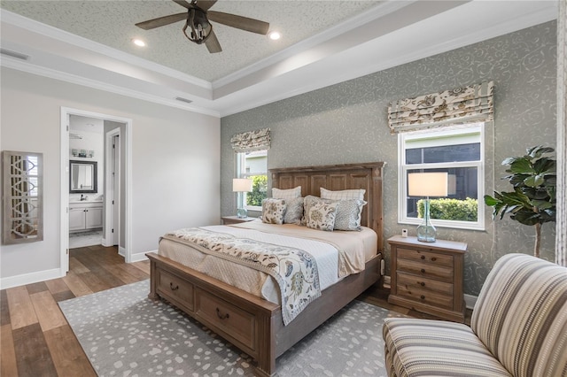 4625 Foxtail Dr, Parrish, FL 34219 - bedroom featuring wood finished floors, ornamental molding, a tray ceiling, recessed lighting, and ensuite bathroom