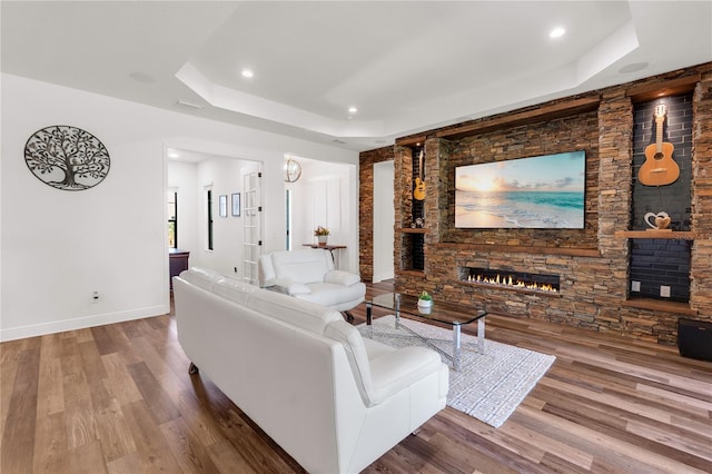 4308 Fly Rod Ter, Parrish, FL 34219 - living area with a fireplace, a tray ceiling, recessed lighting, and wood finished floors