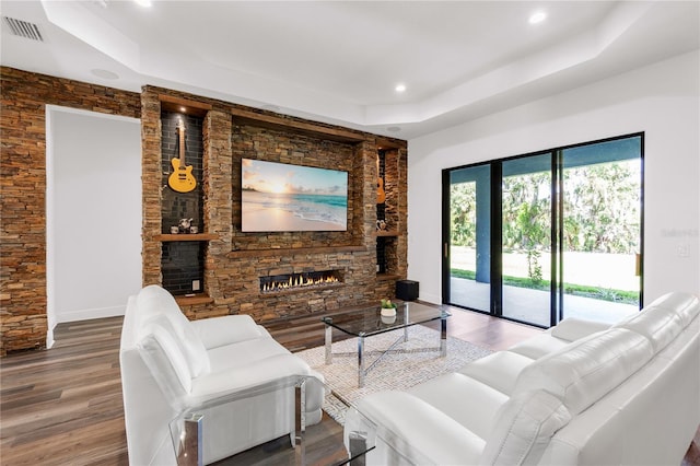 4308 Fly Rod Ter, Parrish, FL 34219 - living area featuring visible vents, a raised ceiling, wood finished floors, and a fireplace