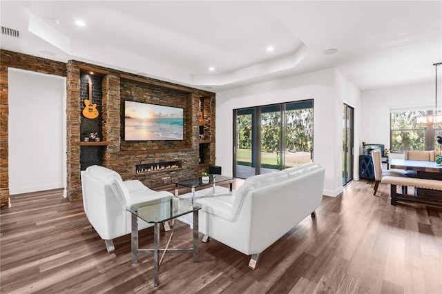 4308 Fly Rod Ter, Parrish, FL 34219 - living room featuring recessed lighting, a raised ceiling, wood finished floors, and a fireplace