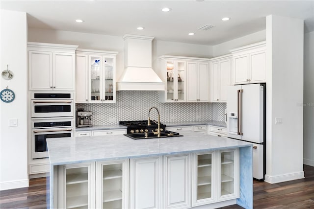 4308 Fly Rod Ter, Parrish, FL 34219 - kitchen with white appliances, baseboards, a sink, and custom range hood
