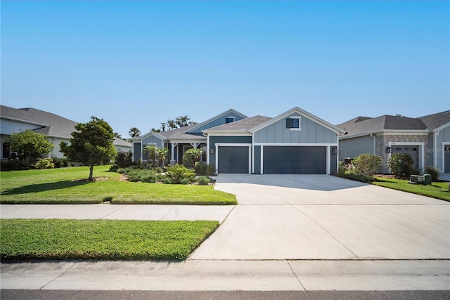 4308 Fly Rod Ter, Parrish, FL 34219 - view of front of property featuring an attached garage, a front lawn, board and batten siding, and concrete driveway
