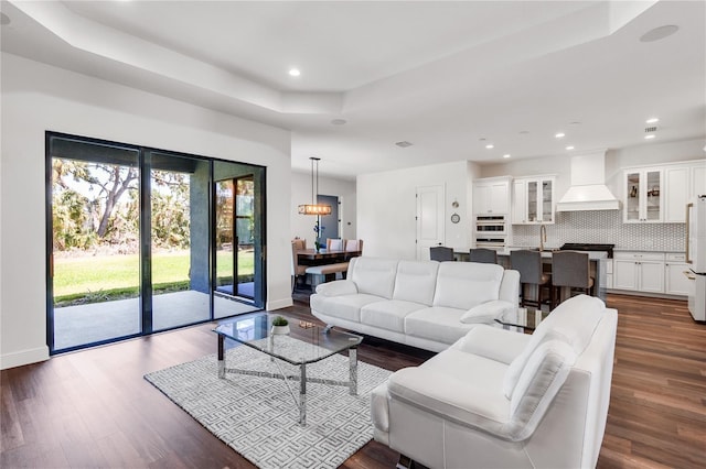4308 Fly Rod Ter, Parrish, FL 34219 - living room featuring recessed lighting, a tray ceiling, dark wood finished floors, and baseboards