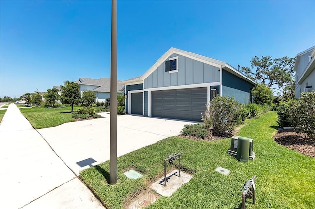 4308 Fly Rod Ter, Parrish, FL 34219 - view of front of property featuring board and batten siding, concrete driveway, a front yard, and a garage