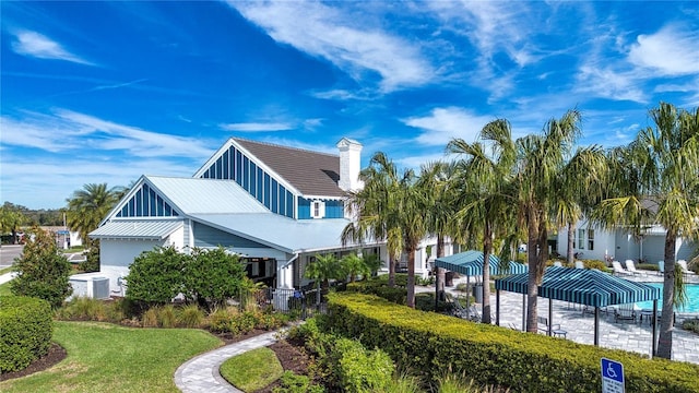 4308 Fly Rod Ter, Parrish, FL 34219 - view of front of house with a front lawn, central air condition unit, and a chimney