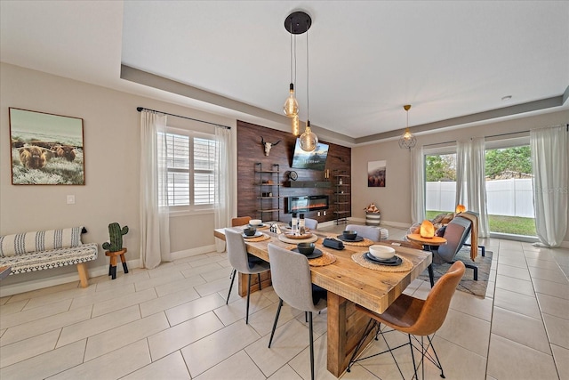 867 Bacon Ave, Sarasota, FL 34232 - dining space with baseboards, a wealth of natural light, a fireplace, and light tile patterned floors
