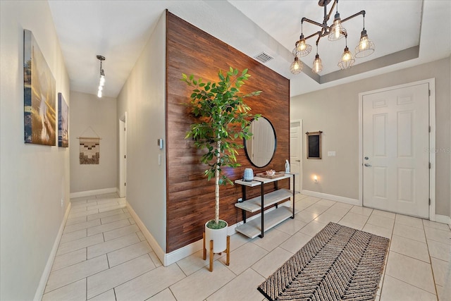 867 Bacon Ave, Sarasota, FL 34232 - foyer featuring baseboards, visible vents, a notable chandelier, and light tile patterned floors