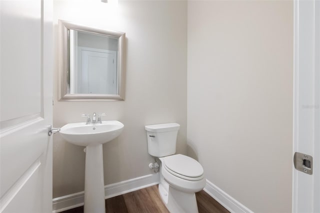 8752 Coastal Key Way, Parrish, FL 34219 - half bath featuring baseboards, wood finished floors, toilet, and a sink