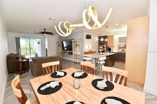 17817 Woodland Ct, Punta Gorda, FL 33982 - dining area with ornamental molding, a chandelier, and ceiling fan