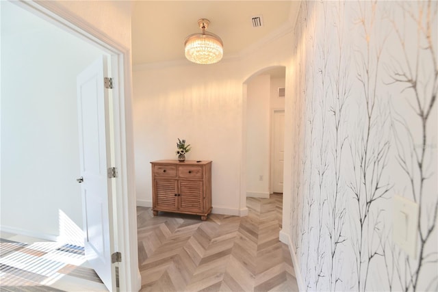 17817 Woodland Ct, Punta Gorda, FL 33982 - corridor with arched walkways, crown molding, and a chandelier