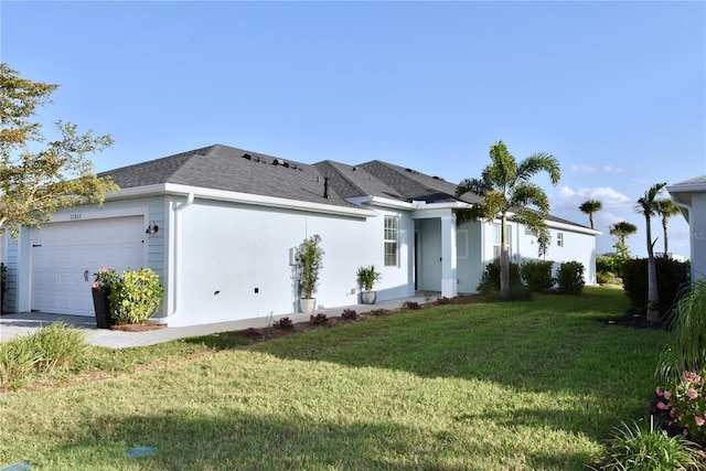 17817 Woodland Ct, Punta Gorda, FL 33982 - view of front of home featuring a garage, a front yard, stucco siding, and a shingled roof