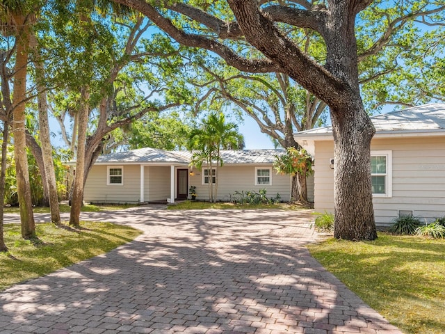 1248 Northport Dr, Sarasota, FL 34242 - ranch-style home featuring a front yard and decorative driveway
