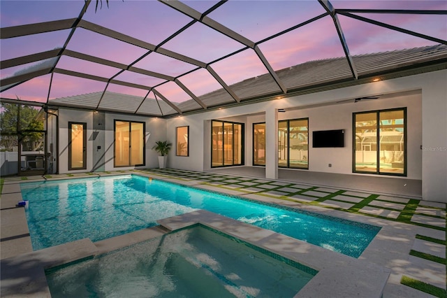 view of swimming pool featuring a patio and a pool with connected hot tub