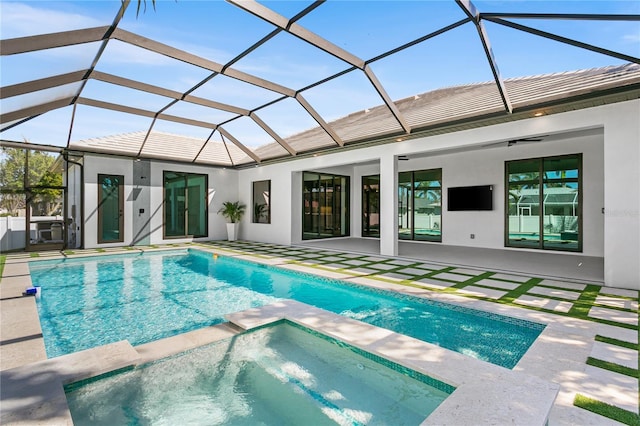 view of swimming pool with a patio, a pool with connected hot tub, and a lanai