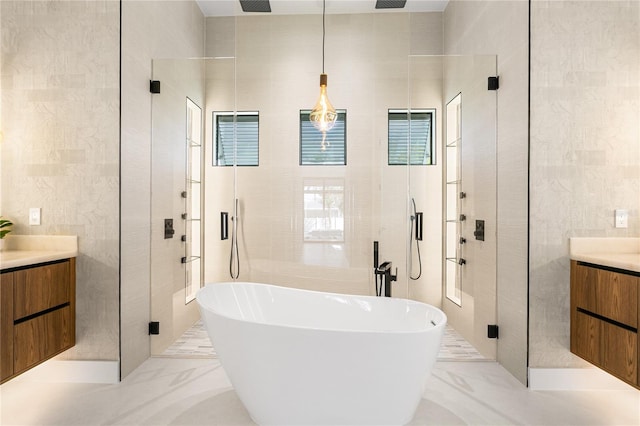 bathroom with vanity, tile walls, and a shower stall