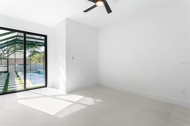 spare room with baseboards and a ceiling fan