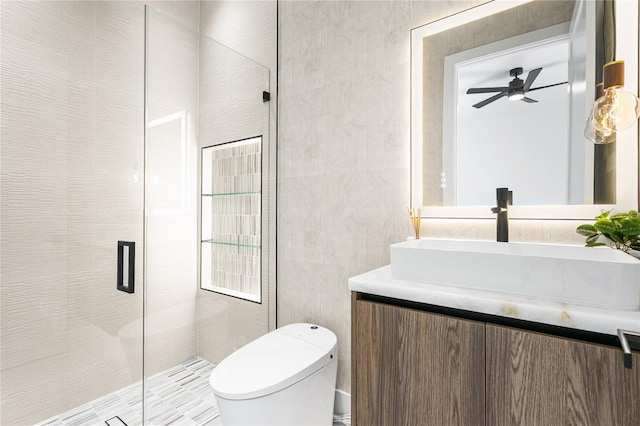 full bathroom featuring vanity, ceiling fan, toilet, and a shower stall