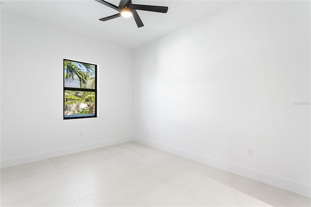 unfurnished room with a ceiling fan and baseboards