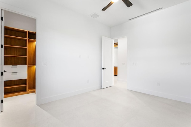 unfurnished bedroom with baseboards, ceiling fan, visible vents, and a spacious closet