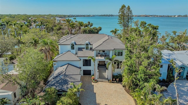 1540 Hillview Dr, Sarasota, FL 34239 - view of front facade featuring a tile roof, stucco siding, stairway, driveway, and a water view