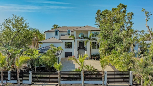 1540 Hillview Dr, Sarasota, FL 34239 - mediterranean / spanish house featuring stucco siding, a balcony, and a fenced front yard