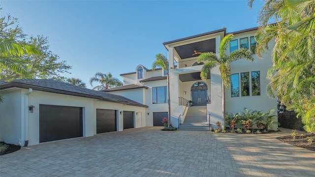 1540 Hillview Dr, Sarasota, FL 34239 - contemporary house featuring decorative driveway, stucco siding, and an attached garage