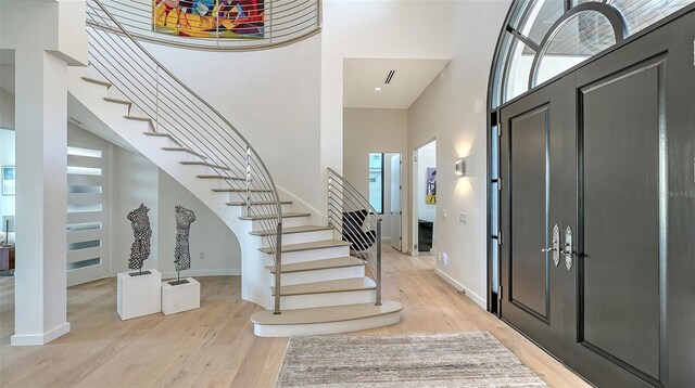 1540 Hillview Dr, Sarasota, FL 34239 - foyer featuring a towering ceiling, baseboards, stairway, and light wood-type flooring