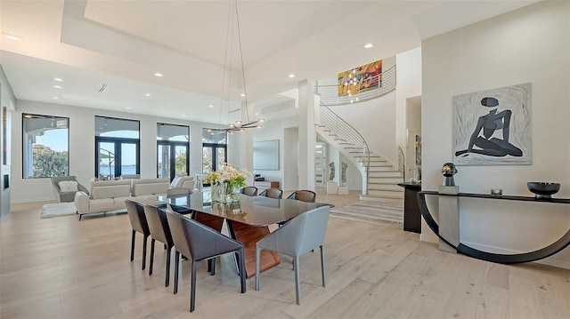 1540 Hillview Dr, Sarasota, FL 34239 - dining room with light wood-style flooring, plenty of natural light, stairway, and a chandelier