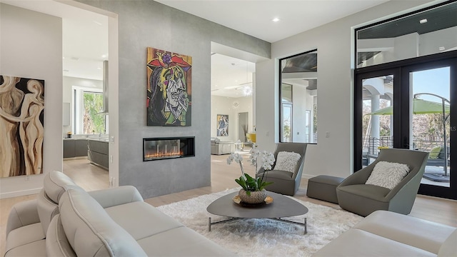 1540 Hillview Dr, Sarasota, FL 34239 - living area featuring light wood finished floors, baseboards, recessed lighting, a glass covered fireplace, and french doors