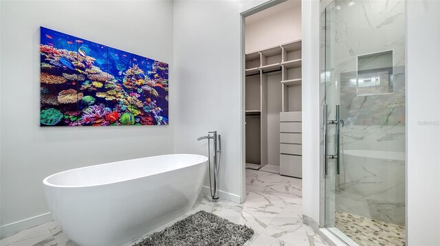 1540 Hillview Dr, Sarasota, FL 34239 - full bath with marble finish floor, a marble finish shower, a spacious closet, and a freestanding bath