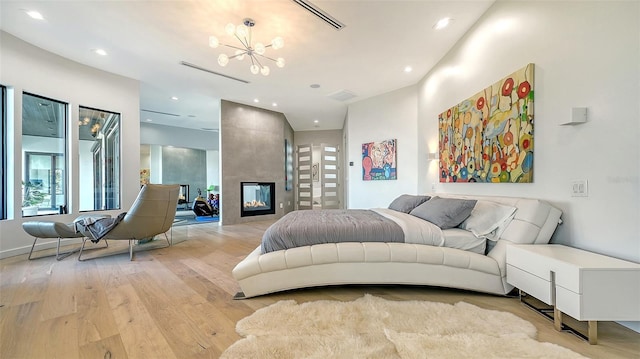 1540 Hillview Dr, Sarasota, FL 34239 - bedroom featuring a notable chandelier, light wood finished floors, a fireplace, visible vents, and recessed lighting