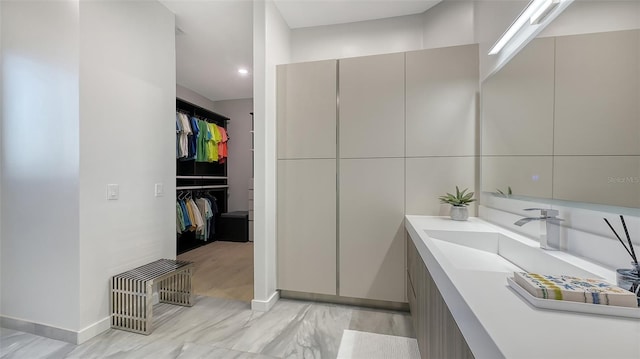 1540 Hillview Dr, Sarasota, FL 34239 - bathroom featuring a spacious closet, vanity, baseboards, and recessed lighting