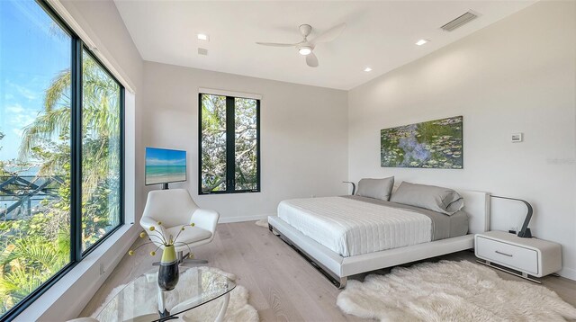 1540 Hillview Dr, Sarasota, FL 34239 - bedroom with a ceiling fan, wood finished floors, multiple windows, and visible vents