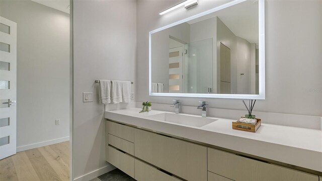 1540 Hillview Dr, Sarasota, FL 34239 - bathroom featuring baseboards, wood finished floors, and vanity