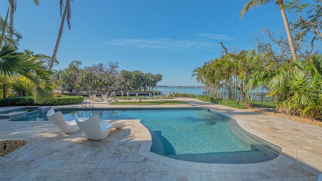 1540 Hillview Dr, Sarasota, FL 34239 - view of pool featuring a water view, fence, a pool with connected hot tub, and a patio area