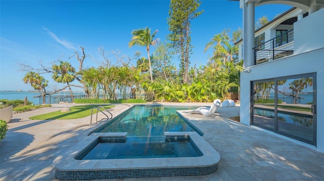 1540 Hillview Dr, Sarasota, FL 34239 - view of pool with fence, a pool with connected hot tub, a water view, and a patio