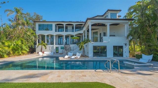 1540 Hillview Dr, Sarasota, FL 34239 - rear view of property with stucco siding, stairs, a balcony, a pool with connected hot tub, and a patio area