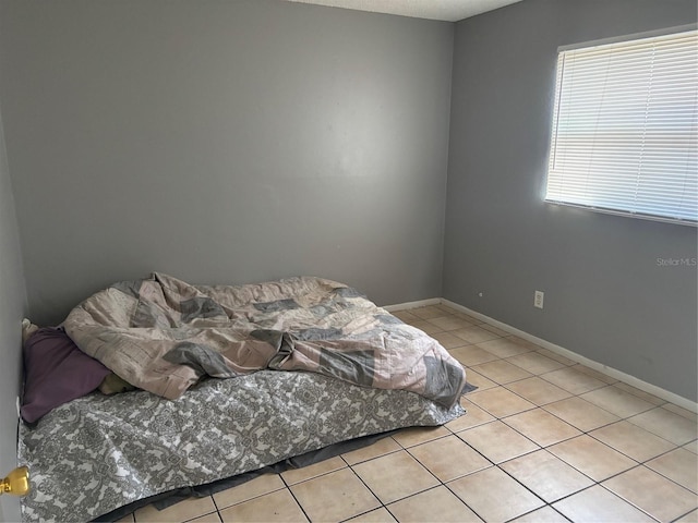 3255 51st Avenue Dr W, Bradenton, FL 34207 - bedroom with light tile patterned floors and baseboards